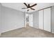Bedroom with neutral carpet, ceiling fan, closet with sliding doors and gray walls at 5228 W Ironwood Dr, Glendale, AZ 85302