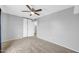 Bedroom with neutral carpet, ceiling fan, closet with sliding doors and gray walls at 5228 W Ironwood Dr, Glendale, AZ 85302