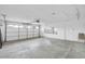 Spacious garage with white walls, concrete floors, and a windowed garage door at 5228 W Ironwood Dr, Glendale, AZ 85302