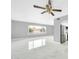 Open-concept living area with smooth floors, a ceiling fan, and a seamless kitchen connection at 5228 W Ironwood Dr, Glendale, AZ 85302