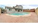 Backyard featuring a kidney shaped pool with a large brick patio, perfect for relaxing at 5228 W Ironwood Dr, Glendale, AZ 85302