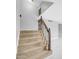 Elegant staircase featuring plush carpeting and classic wooden railings at 5228 W Ironwood Dr, Glendale, AZ 85302