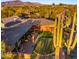 Aerial view of backyard with putting green, desert landscaping, and patio at 5480 E Desert Creek Ln, Cave Creek, AZ 85331