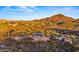 Expansive aerial view of a luxury desert home featuring a private pool and mountain views at 5480 E Desert Creek Ln, Cave Creek, AZ 85331