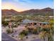 Expansive aerial view of desert home featuring brick architecture, mature cacti, and mountain views in the background at 5480 E Desert Creek Ln, Cave Creek, AZ 85331