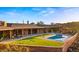Stunning outdoor area with a swimming pool, turf, and relaxing seating at 5480 E Desert Creek Ln, Cave Creek, AZ 85331