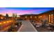 Picturesque backyard featuring a stone walkway, desert landscaping, a covered patio with dining, and beautiful cactus arrangements at 5480 E Desert Creek Ln, Cave Creek, AZ 85331
