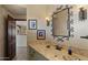 Stylish bathroom with a marble countertop and decorative mirror at 5480 E Desert Creek Ln, Cave Creek, AZ 85331