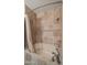 Bathroom with a cream colored tub surrounded by earth tone square tilework and silver plumbing at 5480 E Desert Creek Ln, Cave Creek, AZ 85331