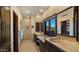Modern bathroom featuring a dual sink vanity with a large mirror and a window at 5480 E Desert Creek Ln, Cave Creek, AZ 85331