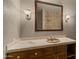 Traditional bathroom featuring warm lighting, granite counters, and wood cabinets below the sink at 5480 E Desert Creek Ln, Cave Creek, AZ 85331