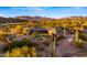 Desert home with a lush lawn and a brick fence offering gorgeous mountain views at 5480 E Desert Creek Ln, Cave Creek, AZ 85331