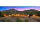 Exterior elevation of a single-story home with mountain views and a brick outdoor space at 5480 E Desert Creek Ln, Cave Creek, AZ 85331