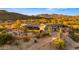 Desert home boasts a beautiful backyard with a lush lawn and brick fence at 5480 E Desert Creek Ln, Cave Creek, AZ 85331