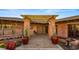 Inviting brick entrance featuring a pergola, potted plants, and desert landscaping creating a welcoming atmosphere at 5480 E Desert Creek Ln, Cave Creek, AZ 85331