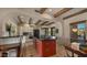 Bright kitchen featuring custom island, white cabinetry and black countertops at 5480 E Desert Creek Ln, Cave Creek, AZ 85331
