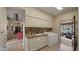 Large laundry room with tile floors, cream colored cabinets and a front-load washer and dryer at 5480 E Desert Creek Ln, Cave Creek, AZ 85331