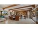 Cozy living room with fireplace, built-in shelves, wood beams, and tile flooring at 5480 E Desert Creek Ln, Cave Creek, AZ 85331