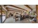Spacious living room with wood beams, fireplace, and glass doors to the yard at 5480 E Desert Creek Ln, Cave Creek, AZ 85331