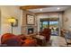 Cozy living room with a brick fireplace and stunning views at 5480 E Desert Creek Ln, Cave Creek, AZ 85331