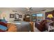 Comfortable main bedroom featuring a ceiling fan, a leather chair, and a sliding glass door with outside views at 5480 E Desert Creek Ln, Cave Creek, AZ 85331