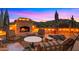 Relaxing outdoor living space with a cozy fireplace and desert scenery at 5480 E Desert Creek Ln, Cave Creek, AZ 85331