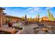 Outdoor brick patio showcasing desert landscape, serene waterfall feature, and comfortable seating areas at 5480 E Desert Creek Ln, Cave Creek, AZ 85331