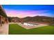 Inviting swimming pool surrounded by lush greenery, with a scenic mountain view in the background at 5480 E Desert Creek Ln, Cave Creek, AZ 85331