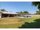 Large backyard featuring pool, patio, and lush green grass at 5501 N 1St St, Phoenix, AZ 85012