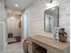 Chic bathroom with patterned wallpaper, wood vanity, and adjacent doorways at 5501 N 1St St, Phoenix, AZ 85012