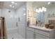 Bright bathroom featuring a glass-enclosed shower with built-in seating and marble countertops and backsplash at 5501 N 1St St, Phoenix, AZ 85012