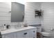 Stylish bathroom features a white vanity with a vessel sink and plank accent wall at 5501 N 1St St, Phoenix, AZ 85012