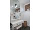 Charming bathroom vanity with drawers, white cabinets, and decorative brick accent wall at 5501 N 1St St, Phoenix, AZ 85012