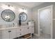 Bright, double sink bathroom with shiplap walls, patterned wallpaper, and stylish decor at 5501 N 1St St, Phoenix, AZ 85012
