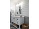 Chic powder room with a white vanity, shiplap accent wall, and modern lighting fixtures at 5501 N 1St St, Phoenix, AZ 85012
