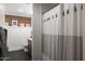 Bathroom with rustic brick accent wall and tiled shower, creating a unique and inviting space at 5501 N 1St St, Phoenix, AZ 85012