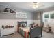 Charming bedroom with a comfortable bed, a desk, and ample natural light streaming through the window at 5501 N 1St St, Phoenix, AZ 85012
