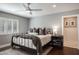 Cozy bedroom with neutral gray walls, decorative pillows, and hardwood floors at 5501 N 1St St, Phoenix, AZ 85012