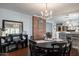 Inviting dining area with brick accent wall, chandelier, and open floor plan leading to the kitchen at 5501 N 1St St, Phoenix, AZ 85012