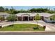 Charming single-story brick home boasts a circular driveway and lush front lawn at 5501 N 1St St, Phoenix, AZ 85012