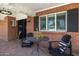 Charming front porch with brick flooring, comfortable seating, and stylish decor at 5501 N 1St St, Phoenix, AZ 85012