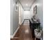 Inviting hallway featuring hardwood floors and a decorative storage cabinet for a warm, stylish welcome at 5501 N 1St St, Phoenix, AZ 85012