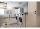 Well-lit laundry room with white cabinets, modern appliances, and decorative tile floor at 5501 N 1St St, Phoenix, AZ 85012