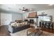 Cozy living room featuring a brick fireplace, hardwood floors, and comfortable seating arrangement at 5501 N 1St St, Phoenix, AZ 85012