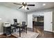 Spacious office features dark wood floors, ceiling fan, desk and doorway to living room at 5501 N 1St St, Phoenix, AZ 85012