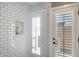 Modern shower features white subway tile and a glass door, complemented by natural light at 5501 N 1St St, Phoenix, AZ 85012