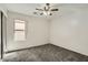 Comfortable carpeted bedroom with ceiling fan and a large window at 5828 E Hampton Ave, Mesa, AZ 85206