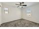 Well-lit bedroom with a ceiling fan and two windows at 5828 E Hampton Ave, Mesa, AZ 85206
