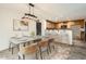 Well-appointed dining area featuring a modern table set, stylish lighting, and adjacent kitchen at 5828 E Hampton Ave, Mesa, AZ 85206