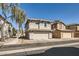 This two-story home has an attached two-car garage and low-maintenance desert landscaping at 5828 E Hampton Ave, Mesa, AZ 85206